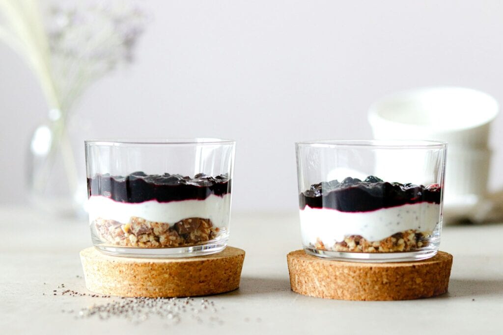 A couple of glasses filled with food on top of a table