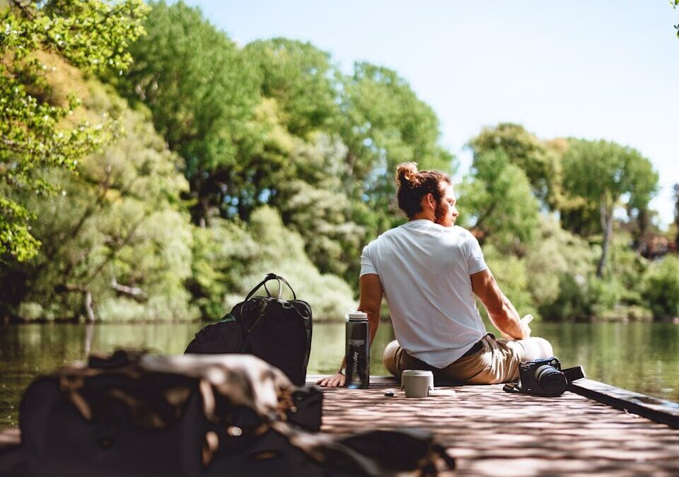 a man sitting on a bench under tender sun
