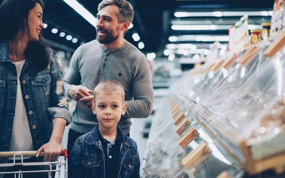 A family shops together in the grocery store.
