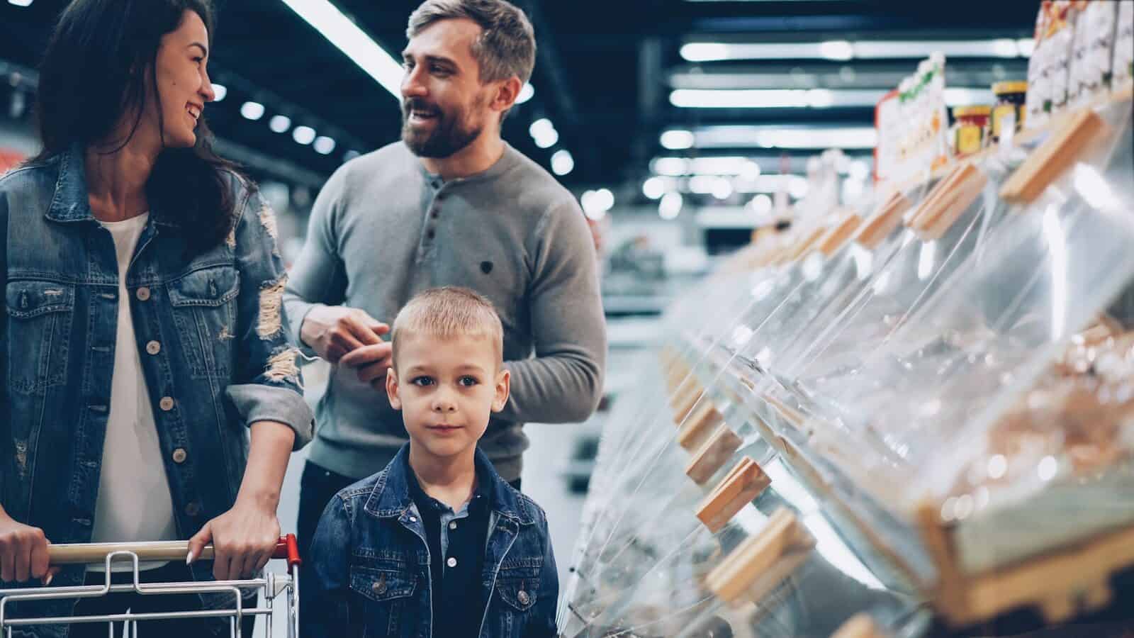 Photo by Vitaly Gariev A family shops together in the grocery store.