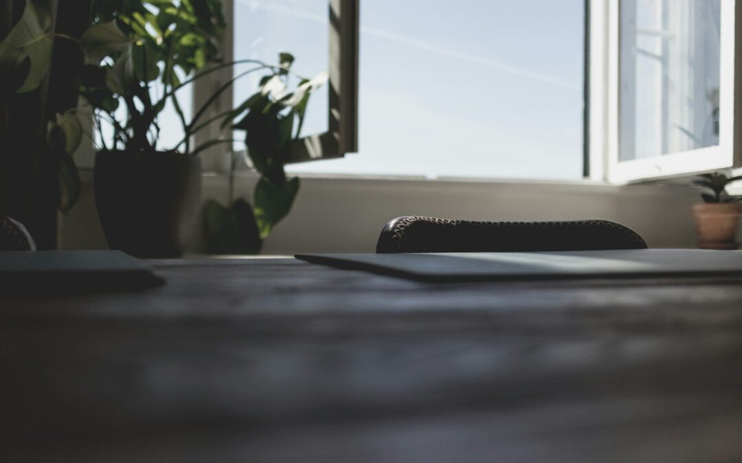 a laptop computer sitting on top of a wooden desk