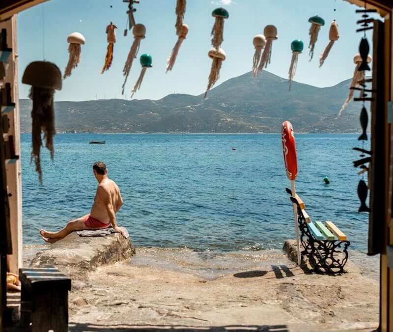 Man relaxing by the sea in milos with jellyfish