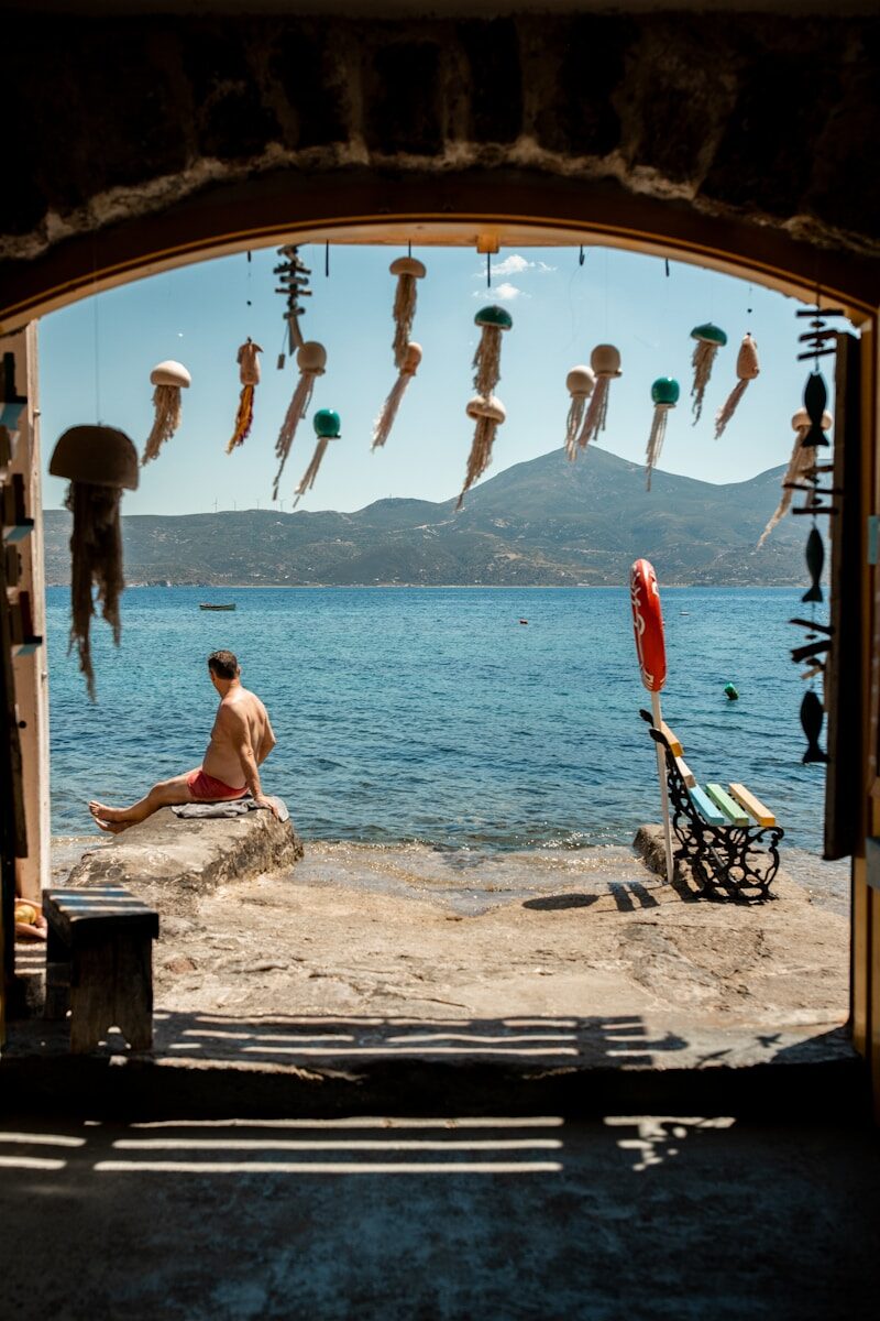 Man relaxing by the sea in milos with jellyfish