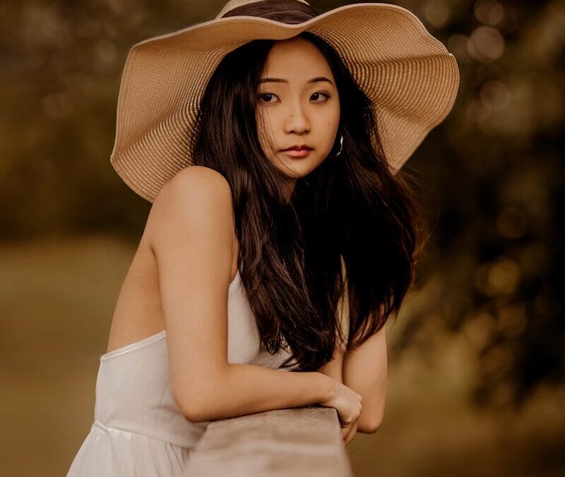 a woman in a hat is posing for a picture