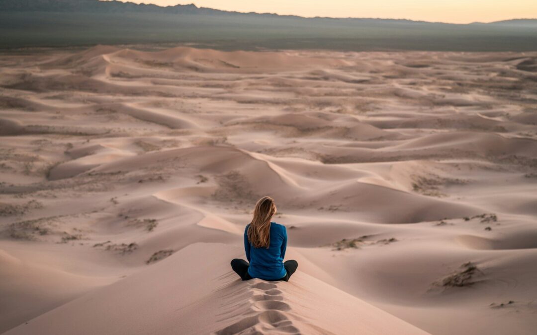 woman sitting on sand field